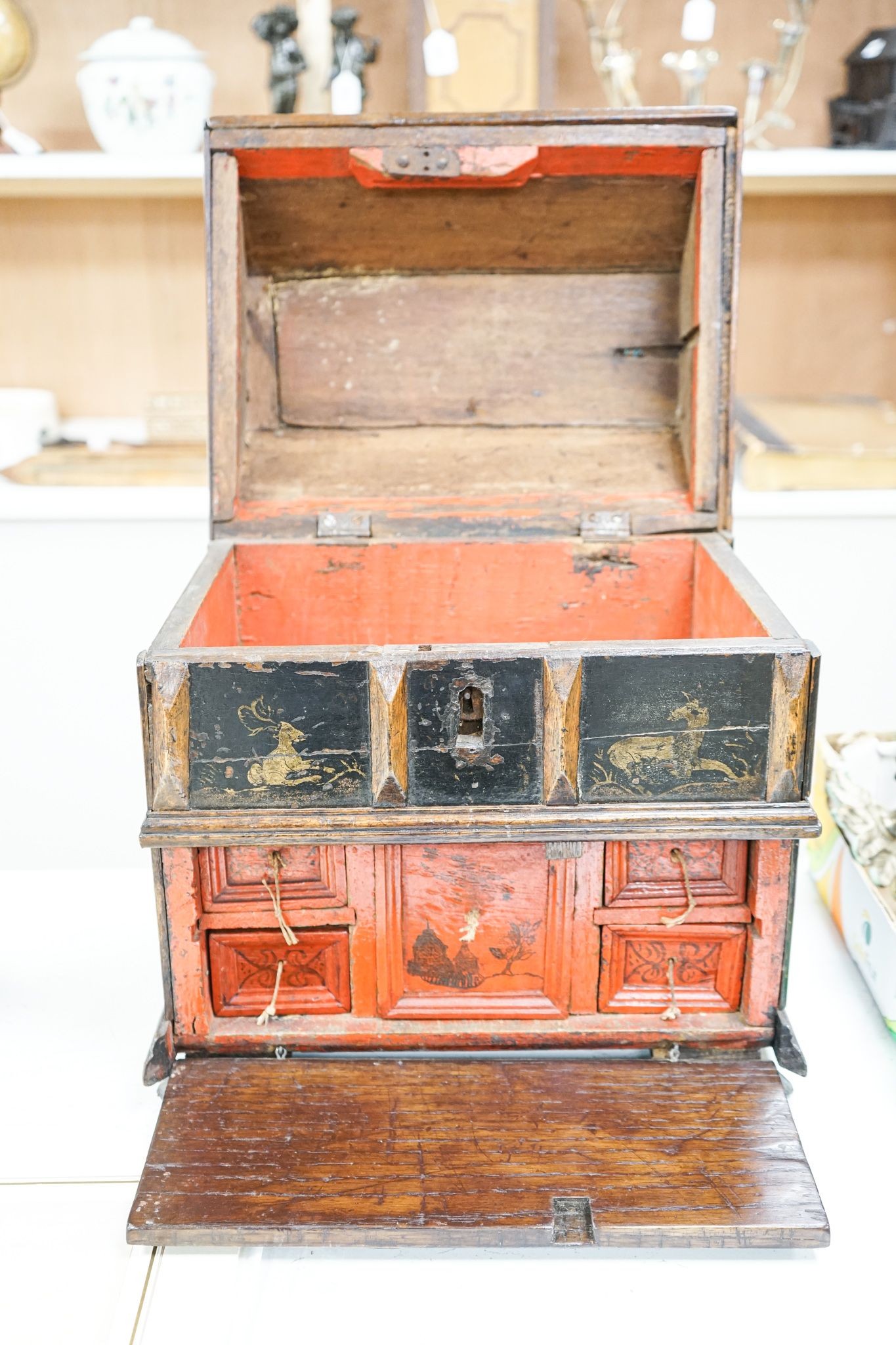 An unusual early 18th century Continental painted chestnut, oak and walnut table-top trunk with concealed drawers 38cm